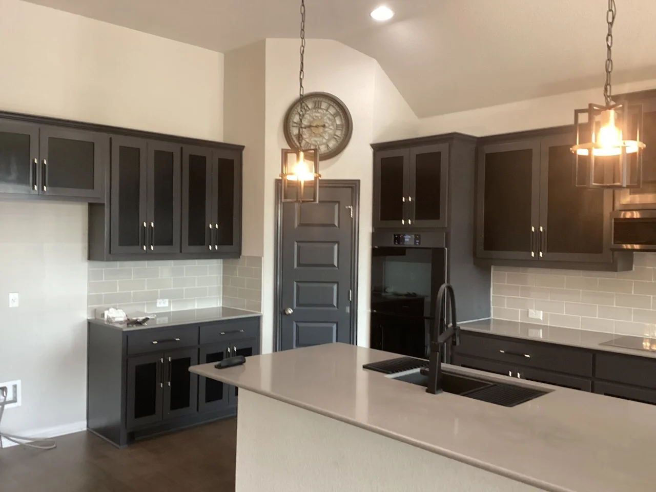 White painted kitchen walls and ceiling with charcoal gray painted cabinetry and trim