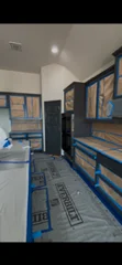 Interior room with newly painted walls and blue trim, professional paint application visible